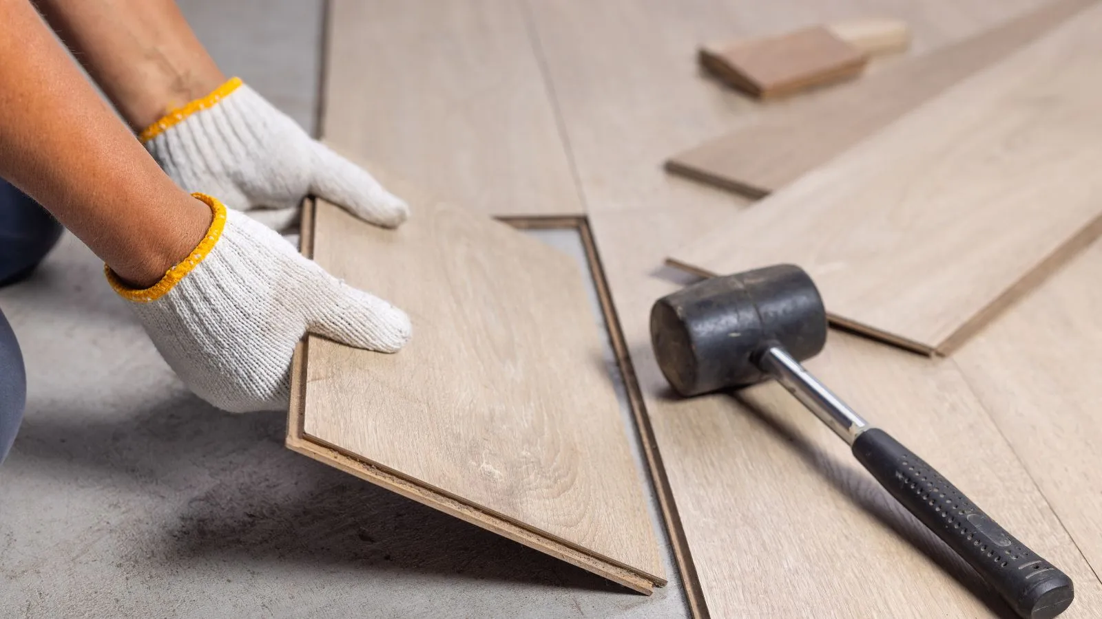 Flooring contractor installing new hardwood floors in a modern home