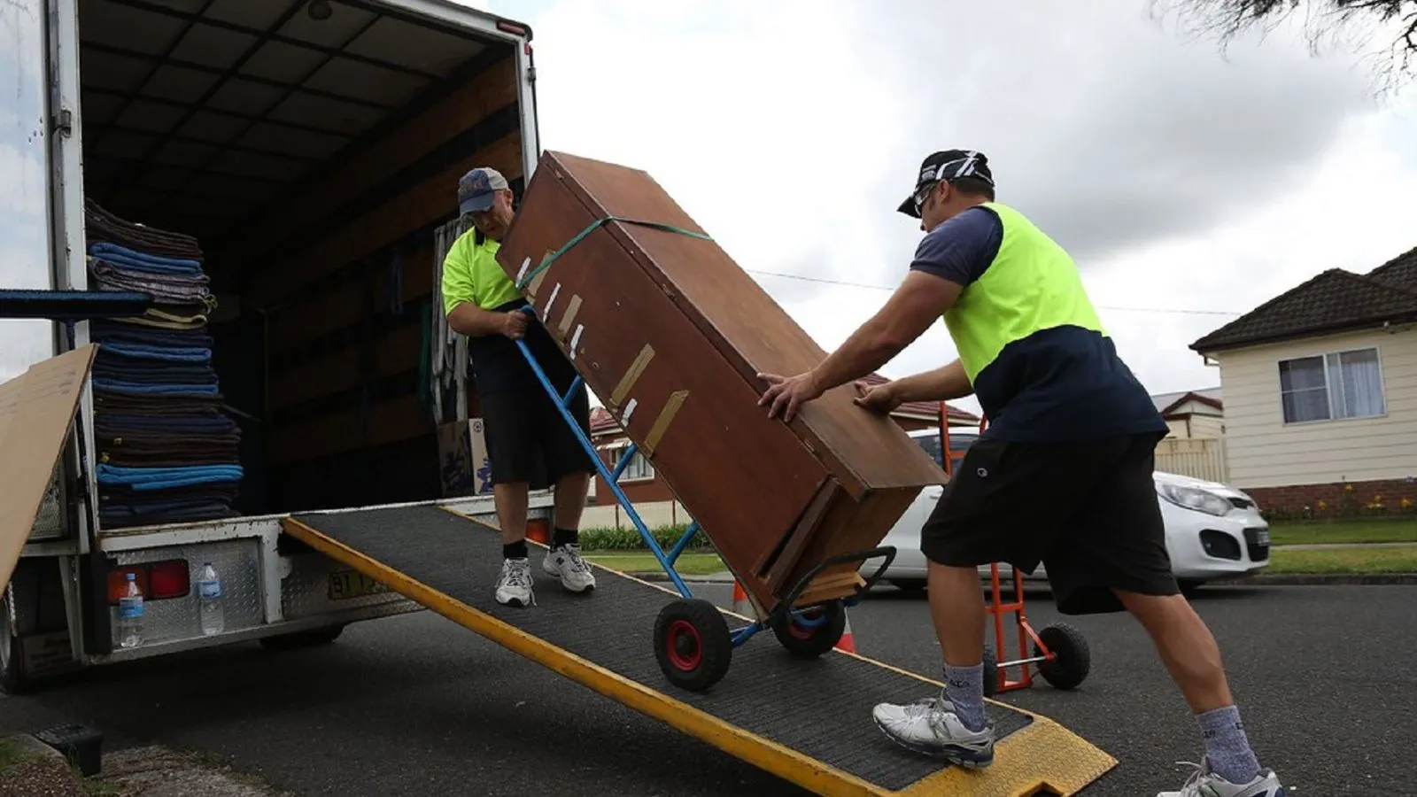 Junk removal team loading old furniture into a hauling truck