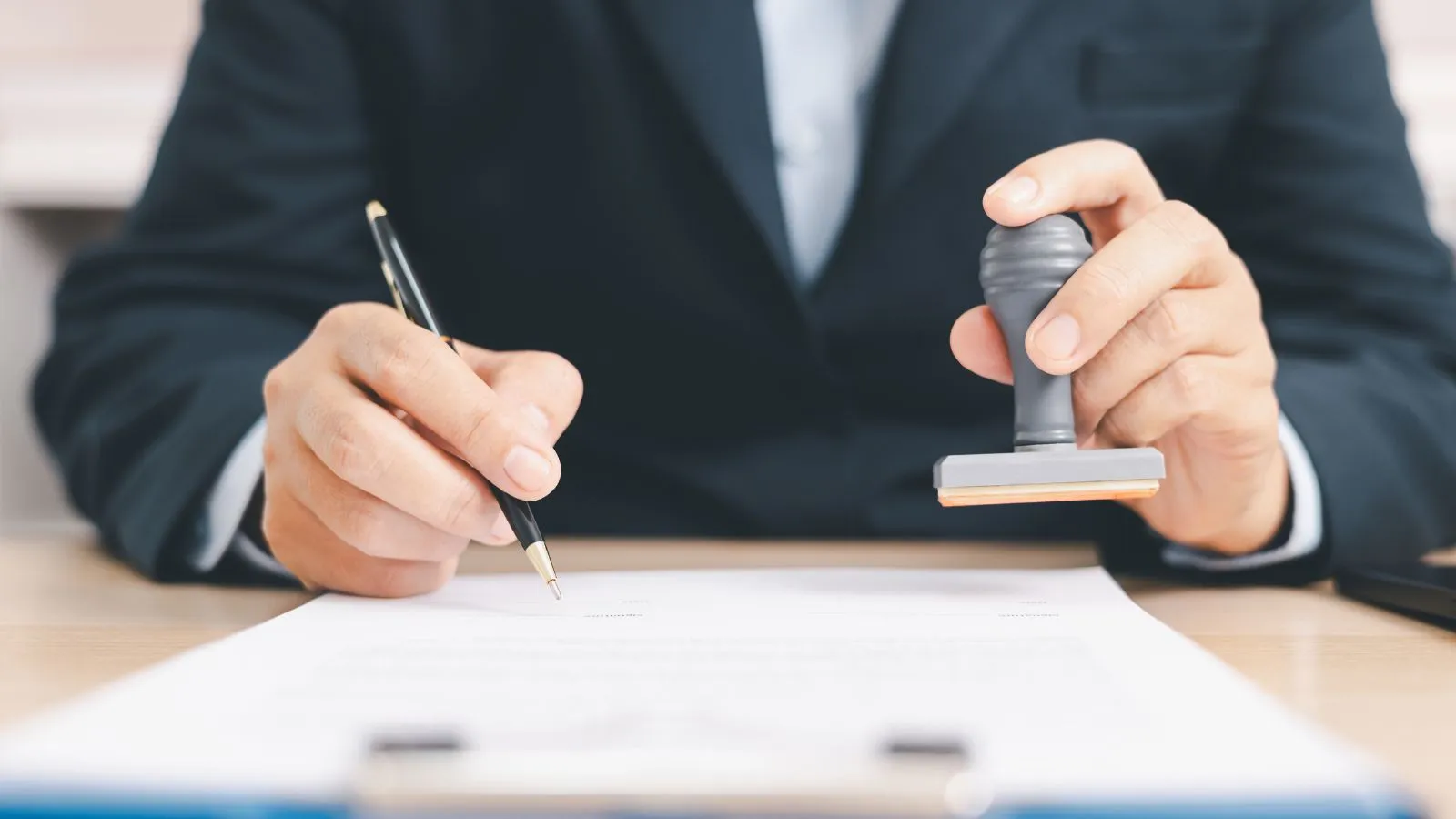 Mobile notary public signing and stamping legal documents for a client
