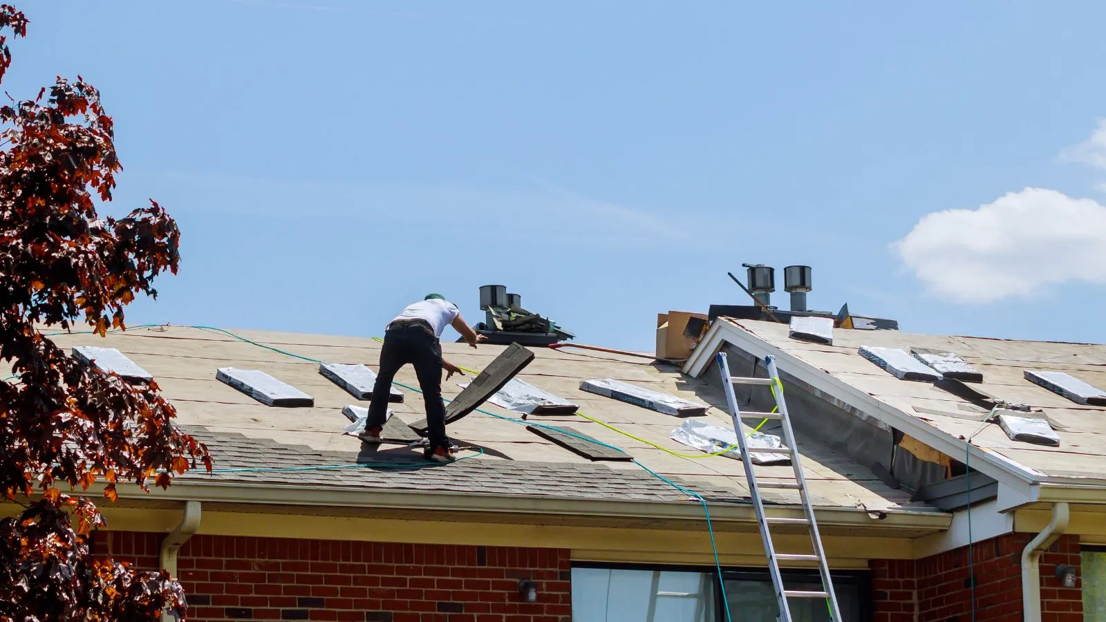 Roofer installing new shingles on a residential home